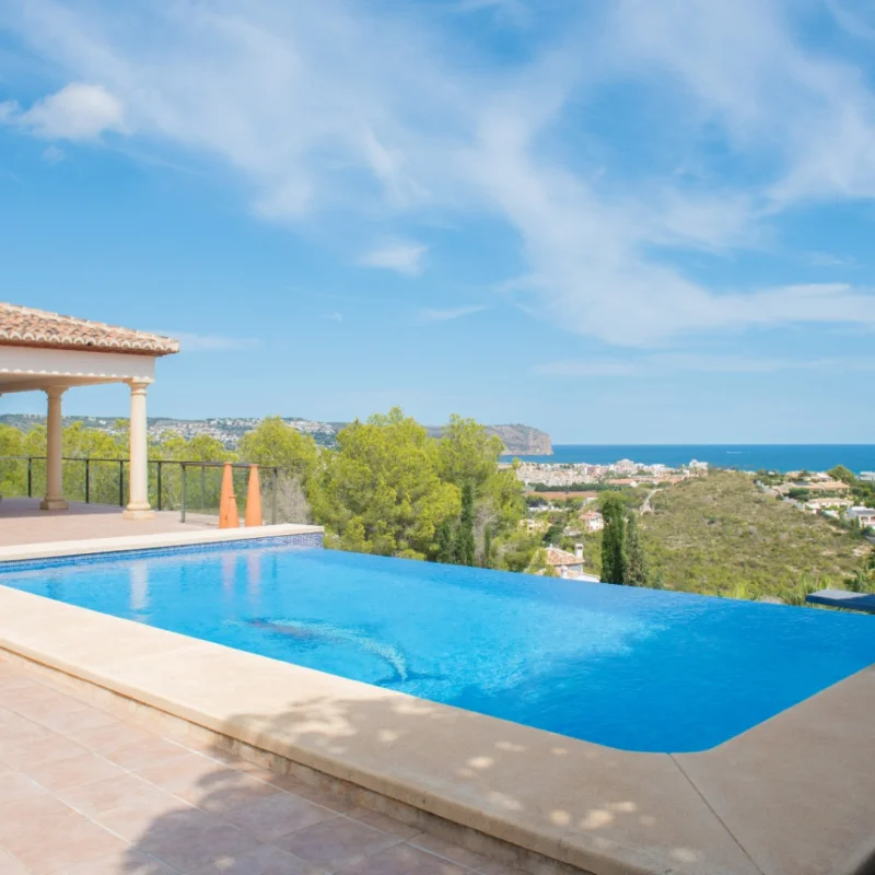 Infinity pool with a ceramic tile terrace and a classic pillared porch. Features panoramic views over the Mediterranean Sea and the Jávea coastline.