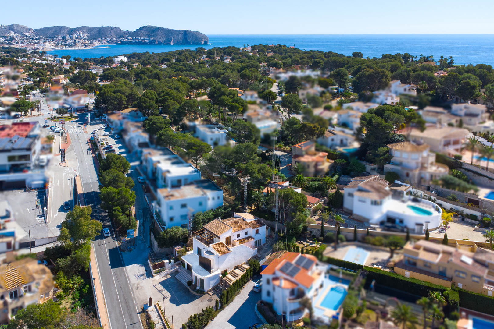 Aerial perspective showing the property's prime location on the Moraira-Calpe road, with panoramic views of the Mediterranean Sea and Cap d'Or.