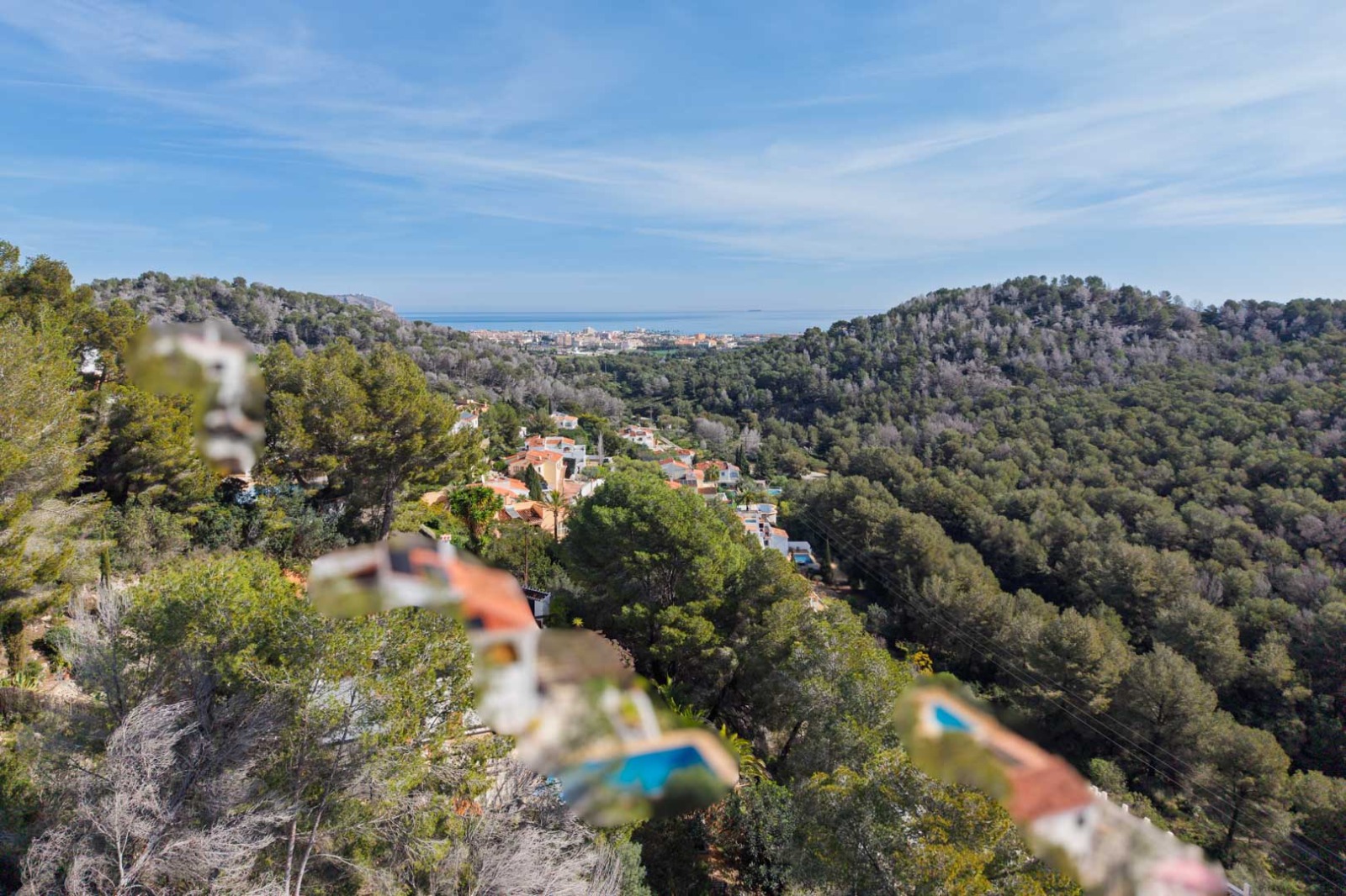 Panoramic views from the plot overlooking pine-covered hills towards the Mediterranean Sea and the coastal town of Jávea.