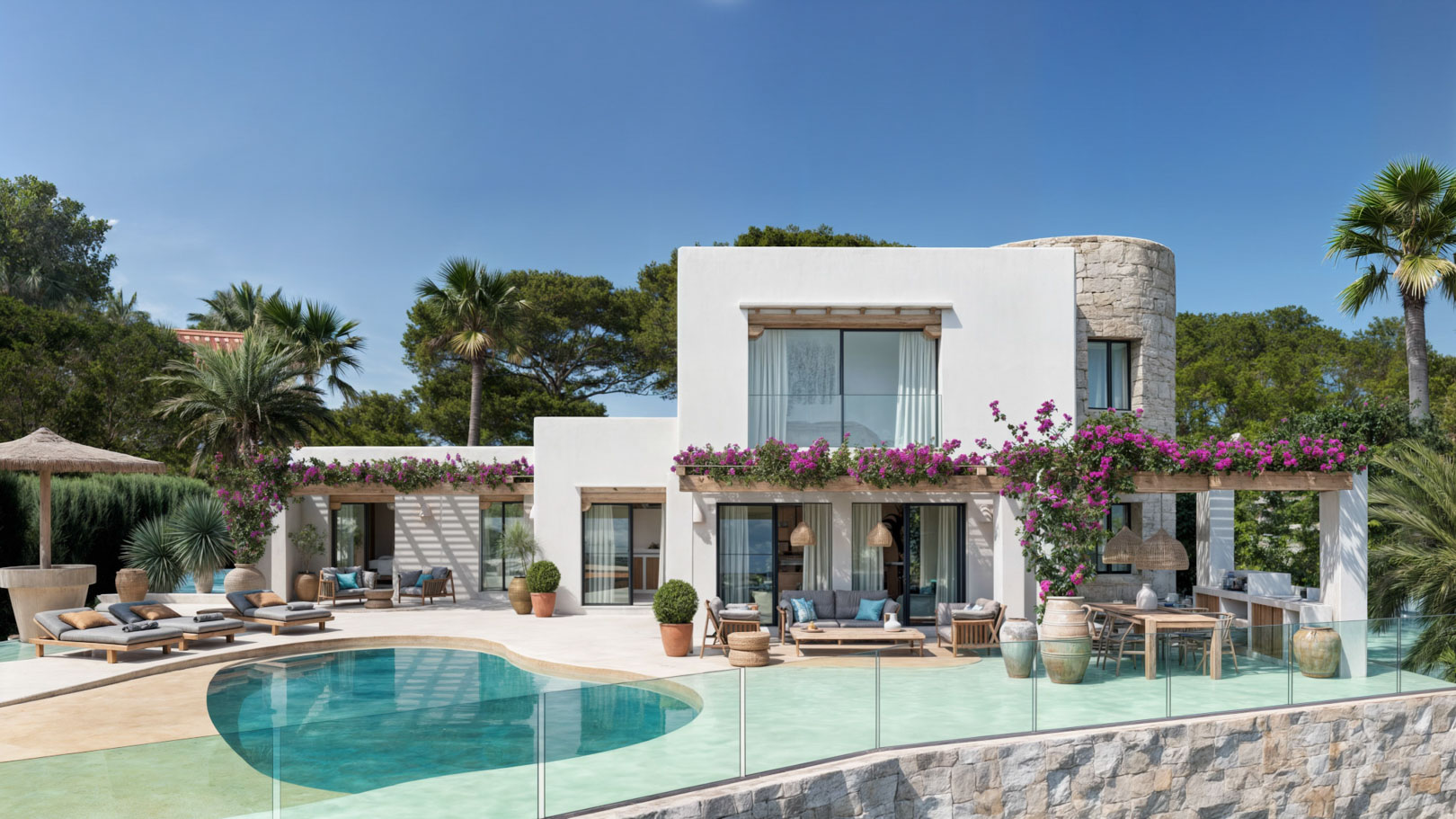Exterior view featuring an organic-shaped pool, natural stone tower, and wooden pergolas with bougainvillea, connecting the terrace to the Ibizan-style architecture.