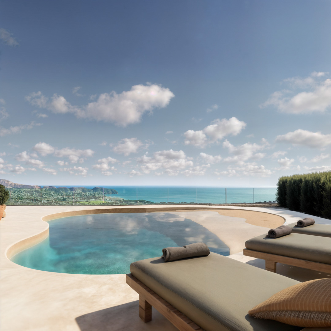 Organic-shaped swimming pool on a microcement terrace featuring wooden sun loungers and panoramic views of the Mediterranean Sea and coastline.