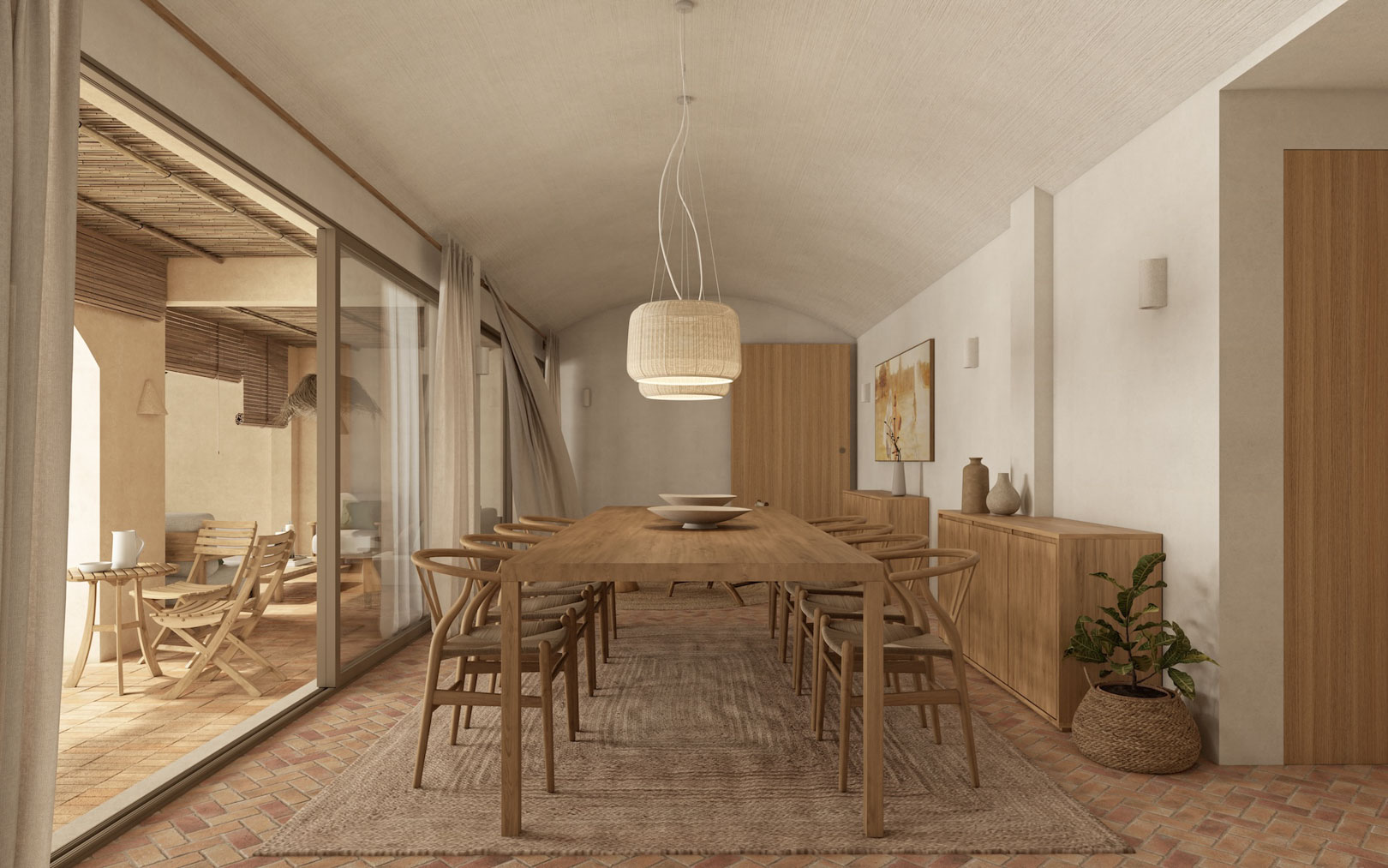 Dining area featuring a vaulted ceiling, wooden table, and Wishbone chairs on terracotta flooring. Large sliding glass doors provide a seamless transition to the covered terrace.