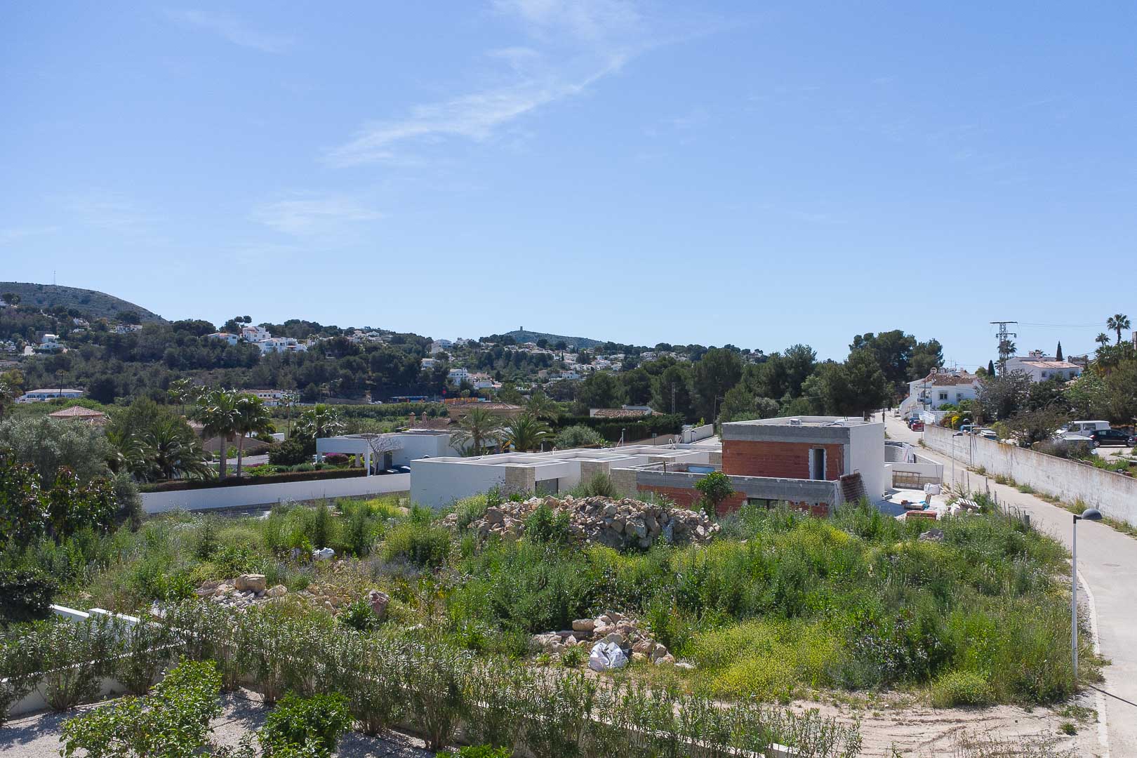 Exterior view of the villa under construction, showcasing the modern structural design and its integration into the Mediterranean hillside of Moraira.