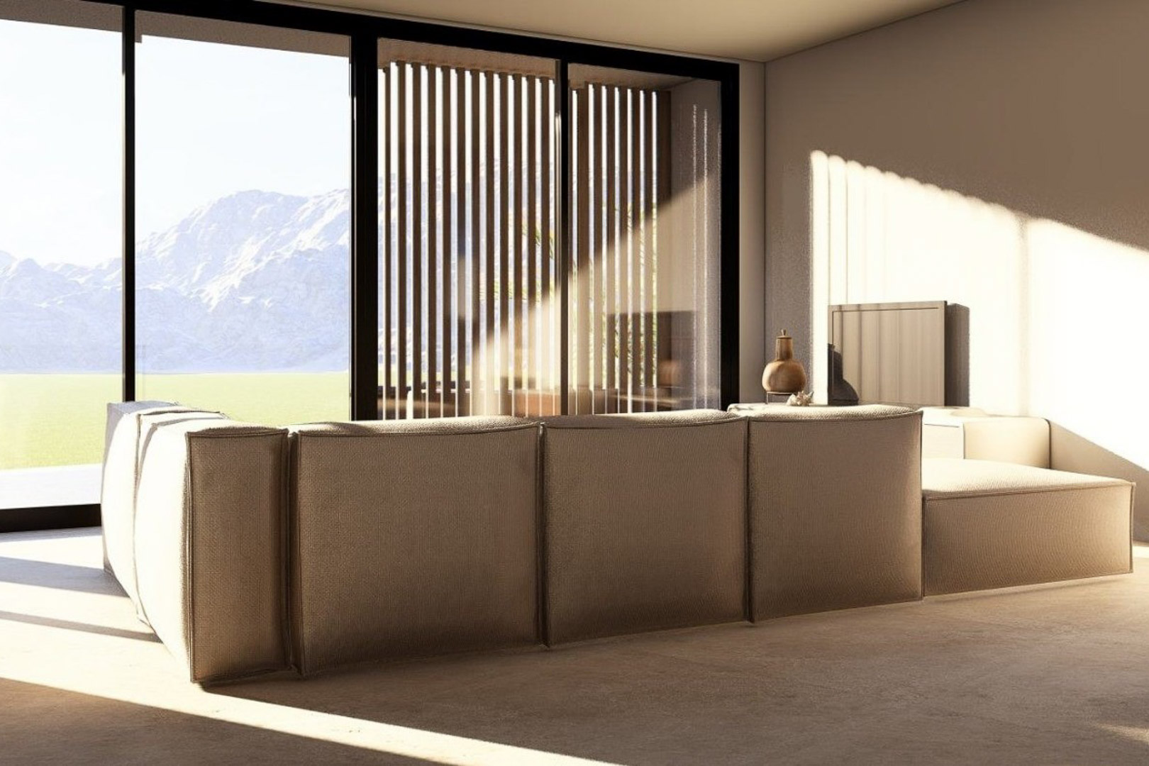 Bright living area featuring a modular earth-toned sofa, floor-to-ceiling glass doors, and panoramic mountain views framed by exterior wooden slats.