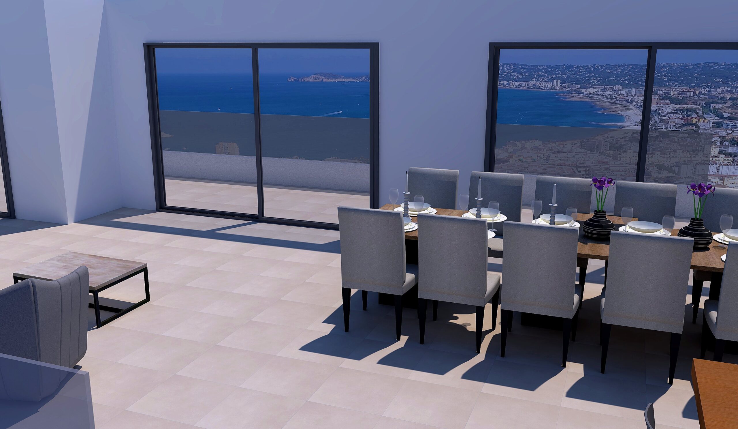 Spacious dining area featuring a large wooden table and sliding glass doors that frame panoramic views of the Mediterranean Sea and Jávea coastline.