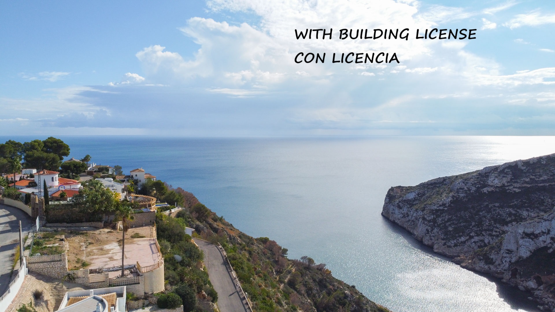 Aerial view of the elevated building plot featuring panoramic views of the Mediterranean Sea and the rugged cliffs of Granadella.