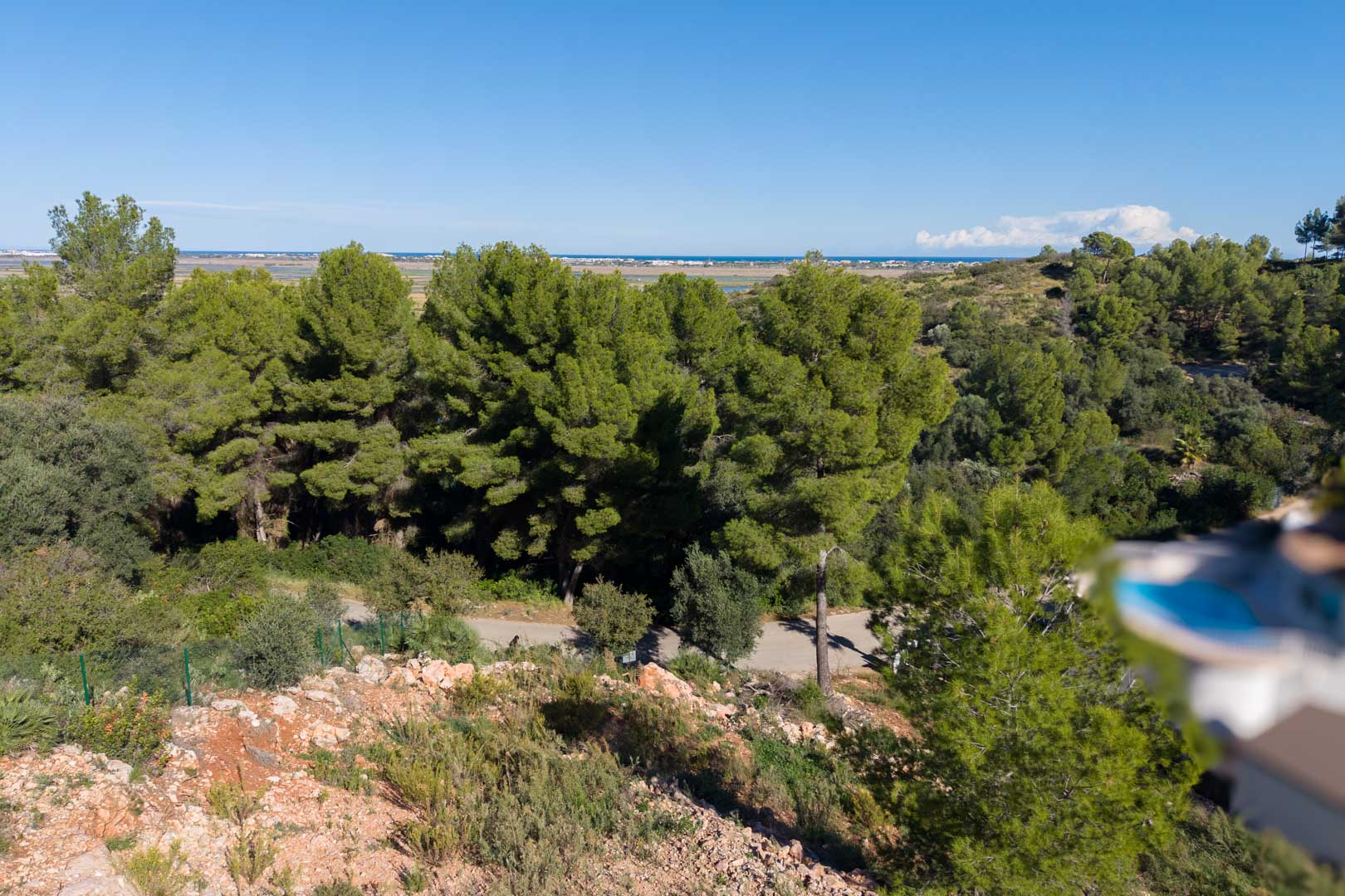 Elevated panoramic views from the plot overlooking the Mediterranean Sea and Marjal Nature Park, surrounded by native pine forests and coastal vegetation.