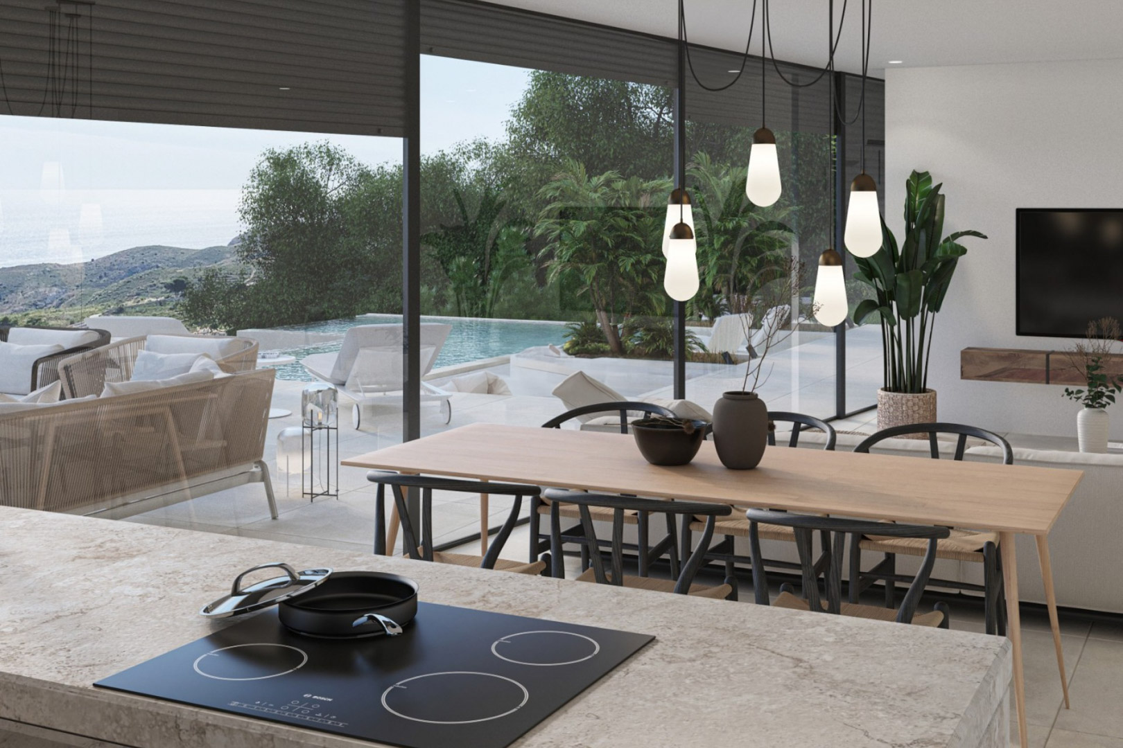 Open-plan living area featuring a stone kitchen island, designer pendant lights, and floor-to-ceiling glass doors opening to the infinity pool and sea views.