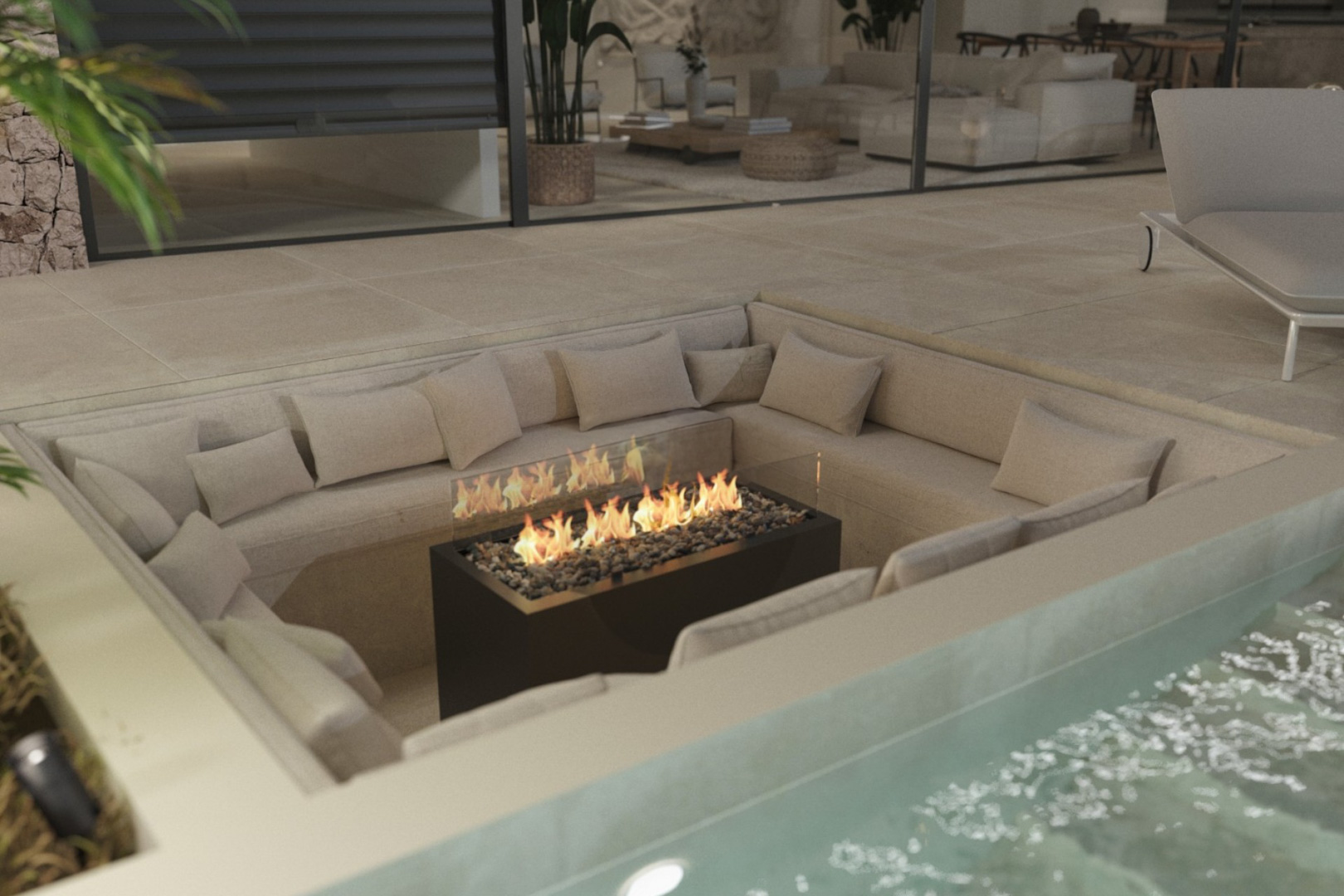 Sunken outdoor lounge area featuring a central gas fire pit with glass protection and integrated beige seating on the stone terrace.