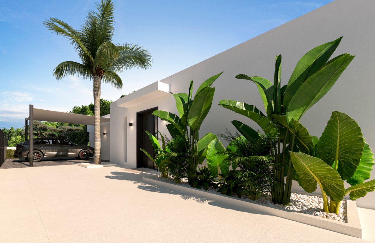 Main entrance featuring a minimalist white facade, dark door, and tropical landscaping with a palm tree. A covered carport provides secure parking on-site.