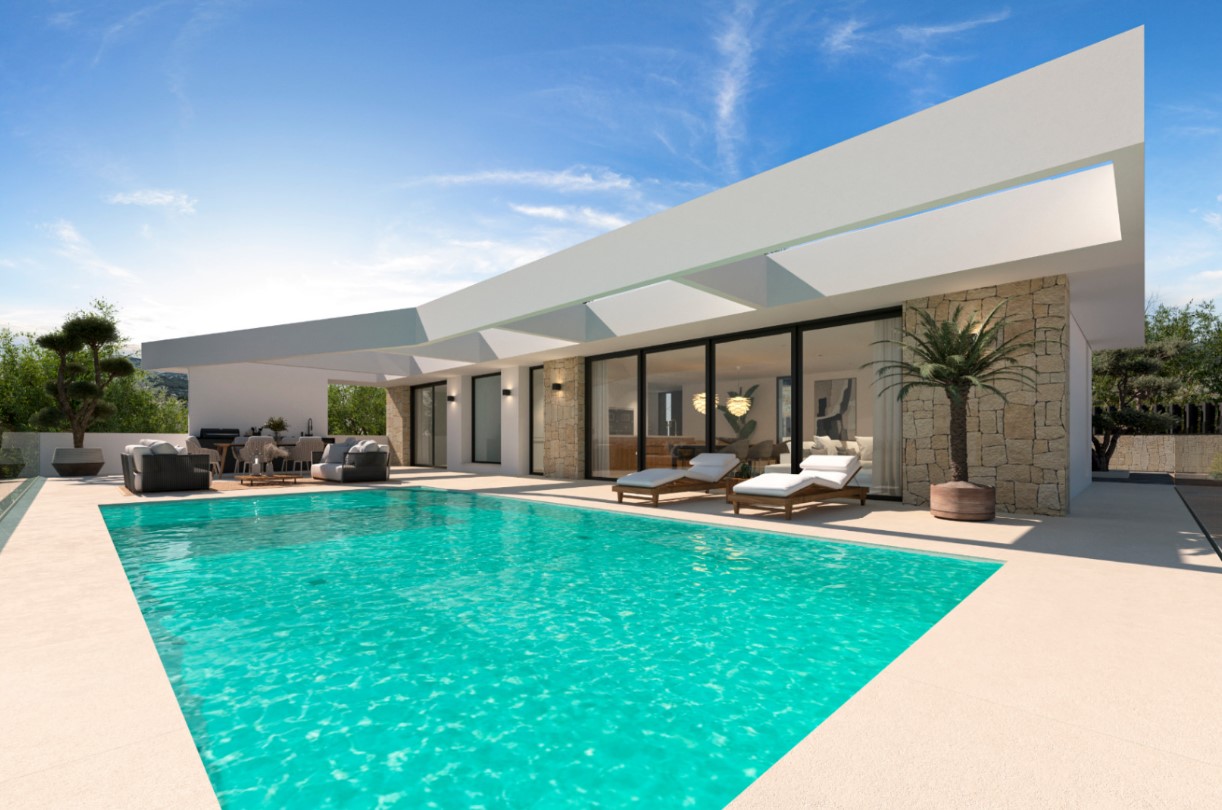 Modern outdoor terrace featuring a turquoise pool, sun loungers, and a covered lounge area. The architecture includes natural stone walls and large glass doors.