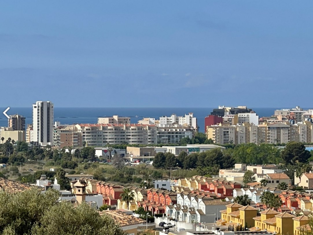 Panoramic views from the property overlooking Calpe's urban landscape, featuring a mix of residential architecture and the Mediterranean Sea on the horizon.