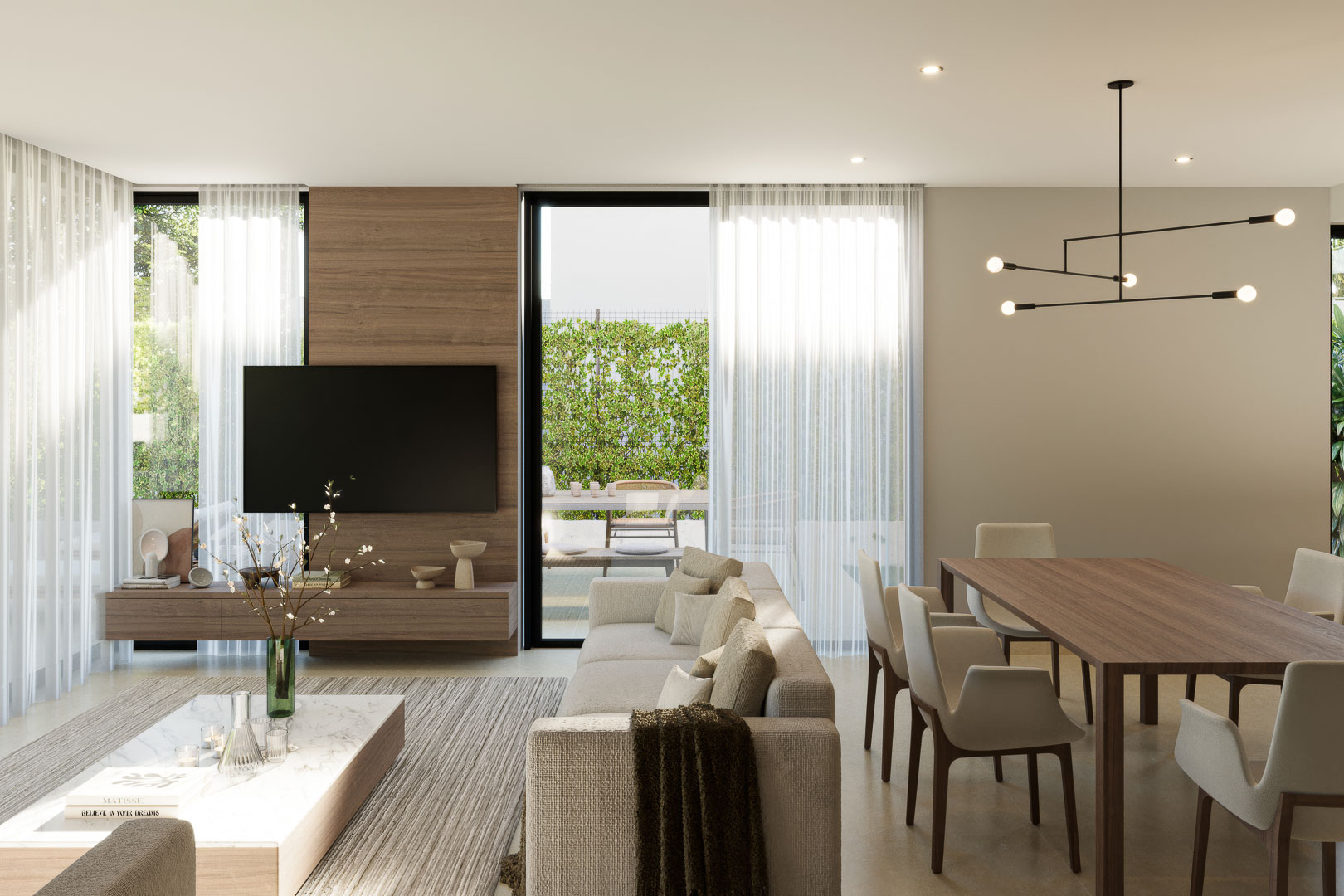 Open-plan living and dining area featuring a wood-paneled accent wall, marble coffee table, and floor-to-ceiling glass doors leading to the garden.