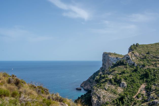 Panoramic views of the Mediterranean coastal cliffs and the blue sea from the natural surroundings of Cumbre del Sol.