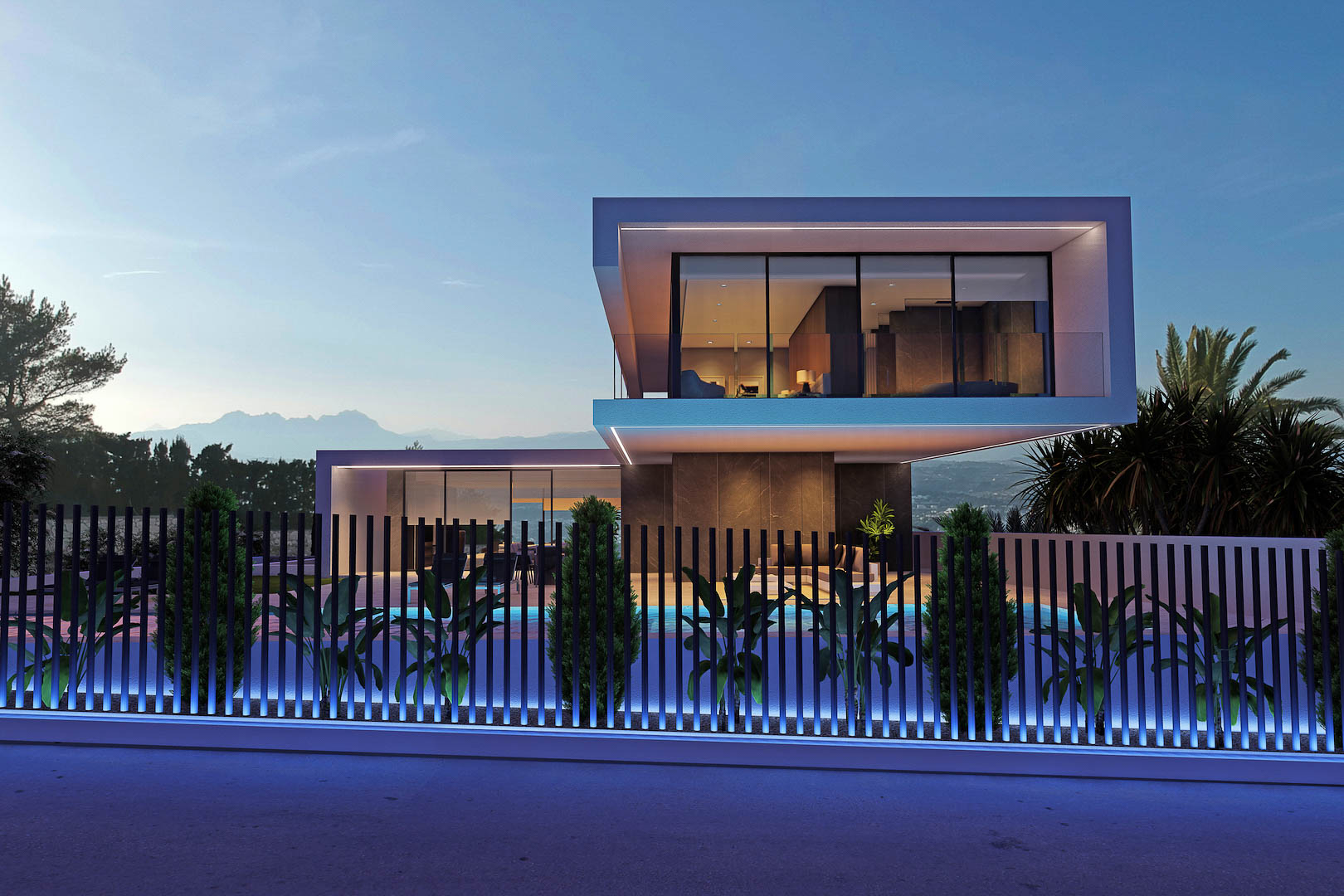 Exterior night view of the villa, featuring an illuminated fence and a glimpse of the pool.