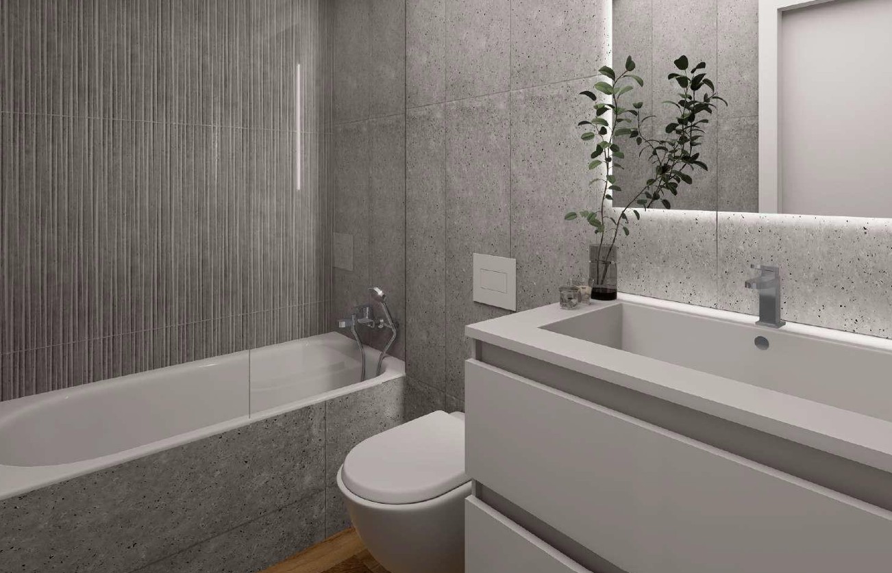 Contemporary bathroom featuring Porcelanosa grey stone-effect tiles, an integrated bathtub with glass screen, and a sleek vanity with an LED-backlit mirror.