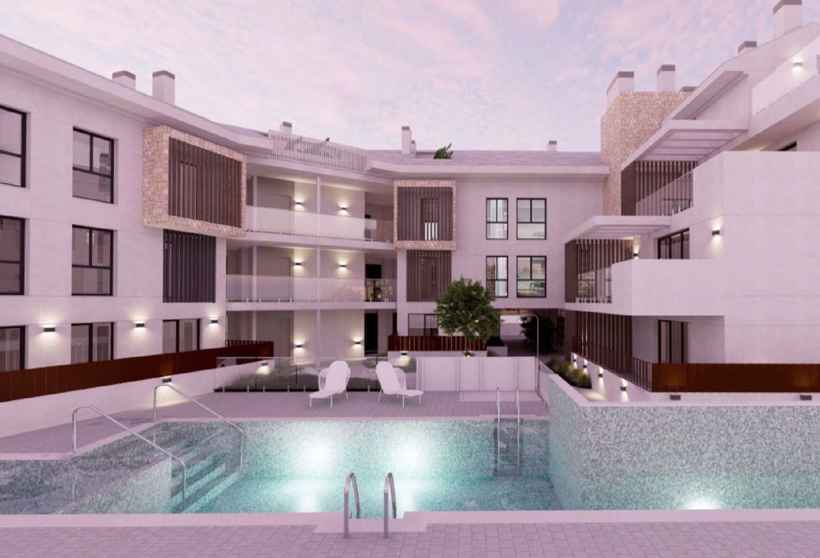 Evening view of the illuminated communal pool area and modern building facades featuring stone accents, wooden louvers, and glass-railed terraces.