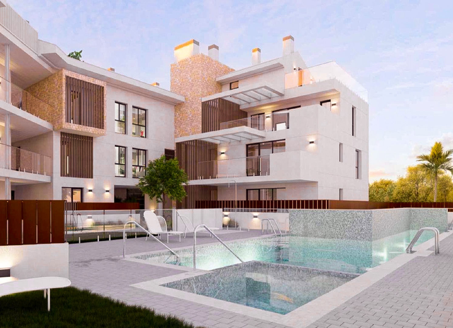 Exterior view of the complex featuring an illuminated communal pool, white facades with natural stone accents, and spacious terraces with glass railings.