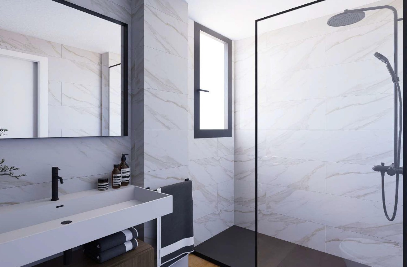 Modern bathroom featuring Porcelanosa marble-effect tiling, a walk-in shower with black framing, and an integrated white sink with matte black fixtures.