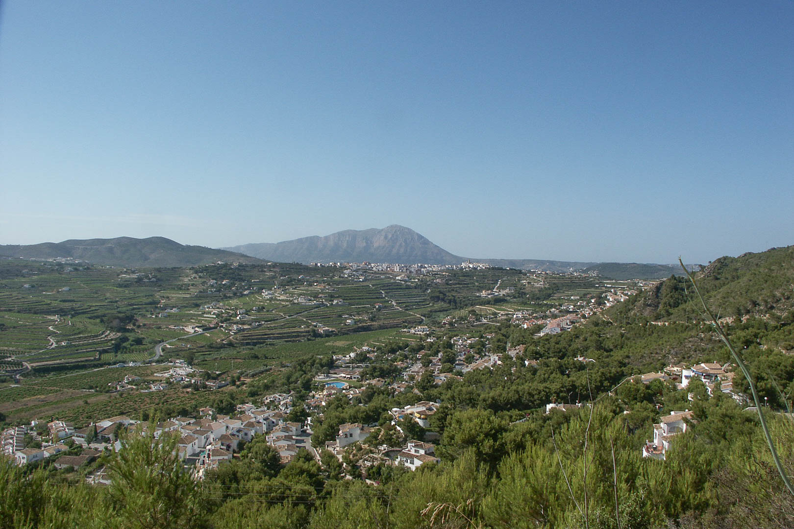 Panoramic views from the Paichi plot overlooking the valley and Montgó mountain, showcasing the natural Mediterranean landscape and residential area.