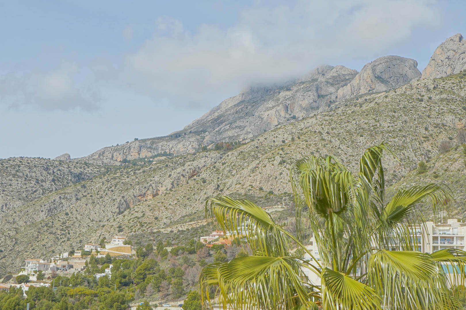 Panoramic views of the Sierra de Bernia mountain range, showing the rugged limestone peaks and Mediterranean greenery from the villa's elevated position.