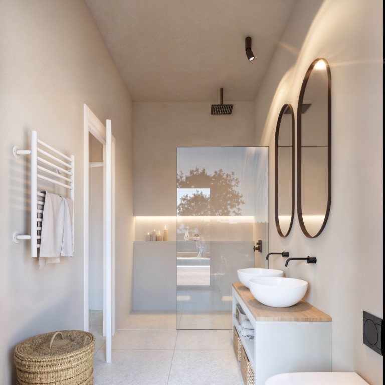 Modern bathroom featuring a double vanity with vessel sinks, black wall-mounted faucets, backlit oval mirrors, and a walk-in shower with integrated LED lighting.