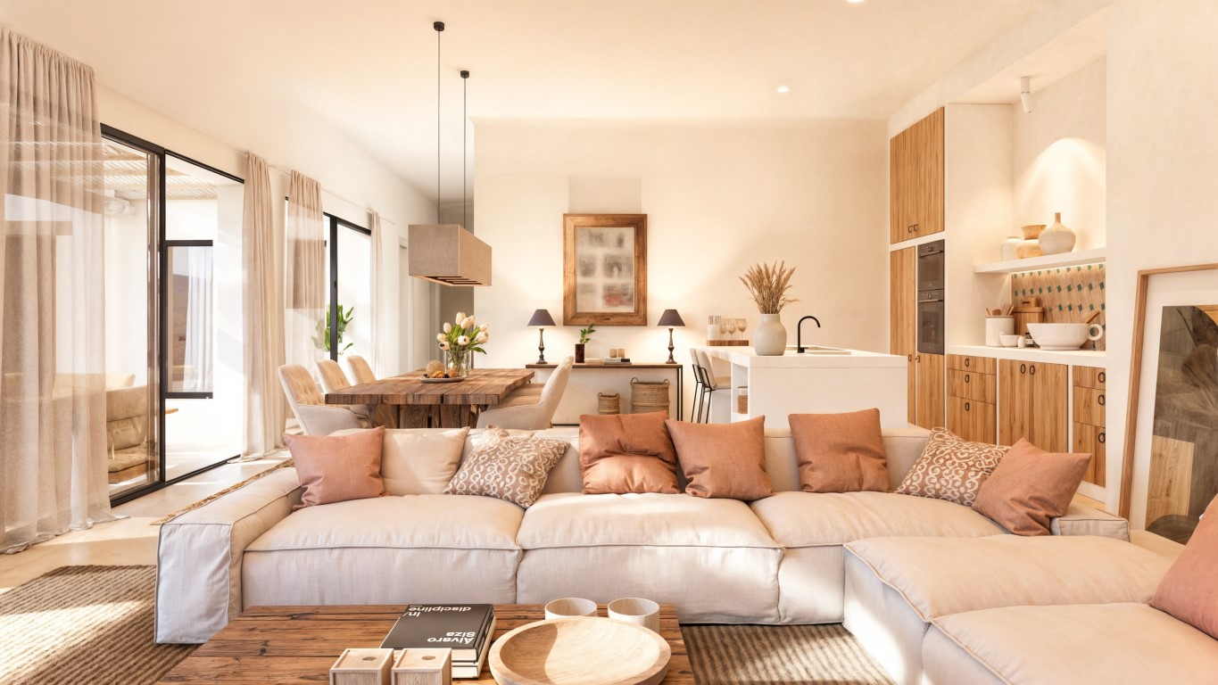 Open-plan living space featuring a modular sofa, solid wood dining table, and a designer kitchen with a white island and integrated wooden cabinetry.