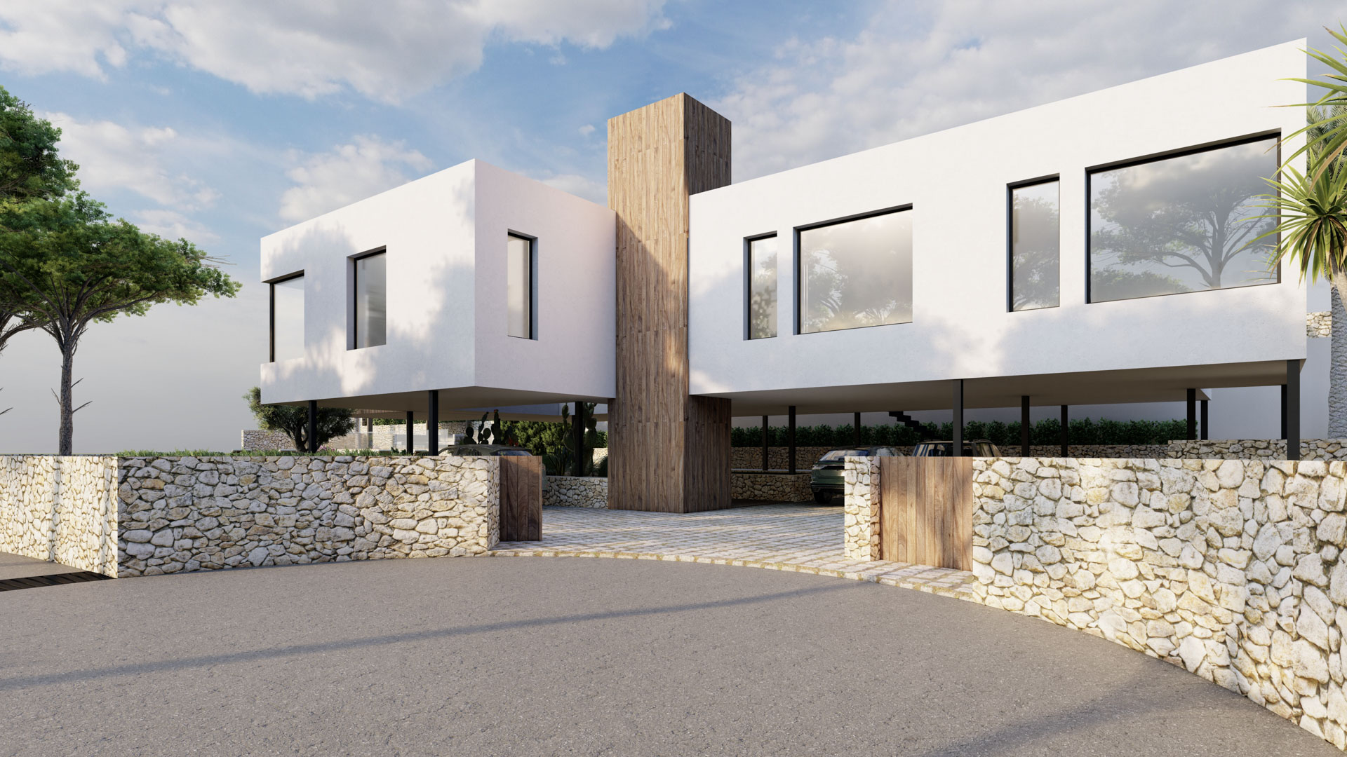 Modern facade featuring white volumes and a central wood-clad element. The elevated upper floor on pillars provides a spacious covered parking area behind natural stone walls.