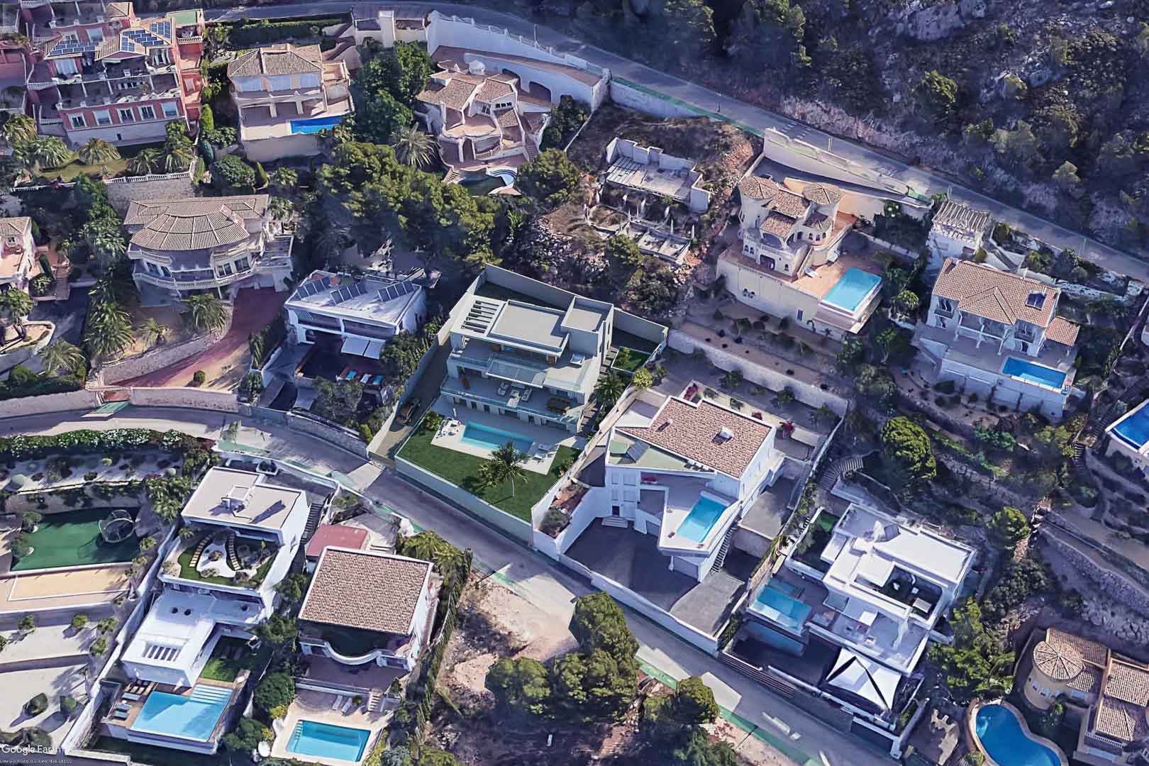 Aerial view of the modern villa in Altea Hills, showcasing its multi-level architecture, private swimming pool, and lawn area within the hillside development.