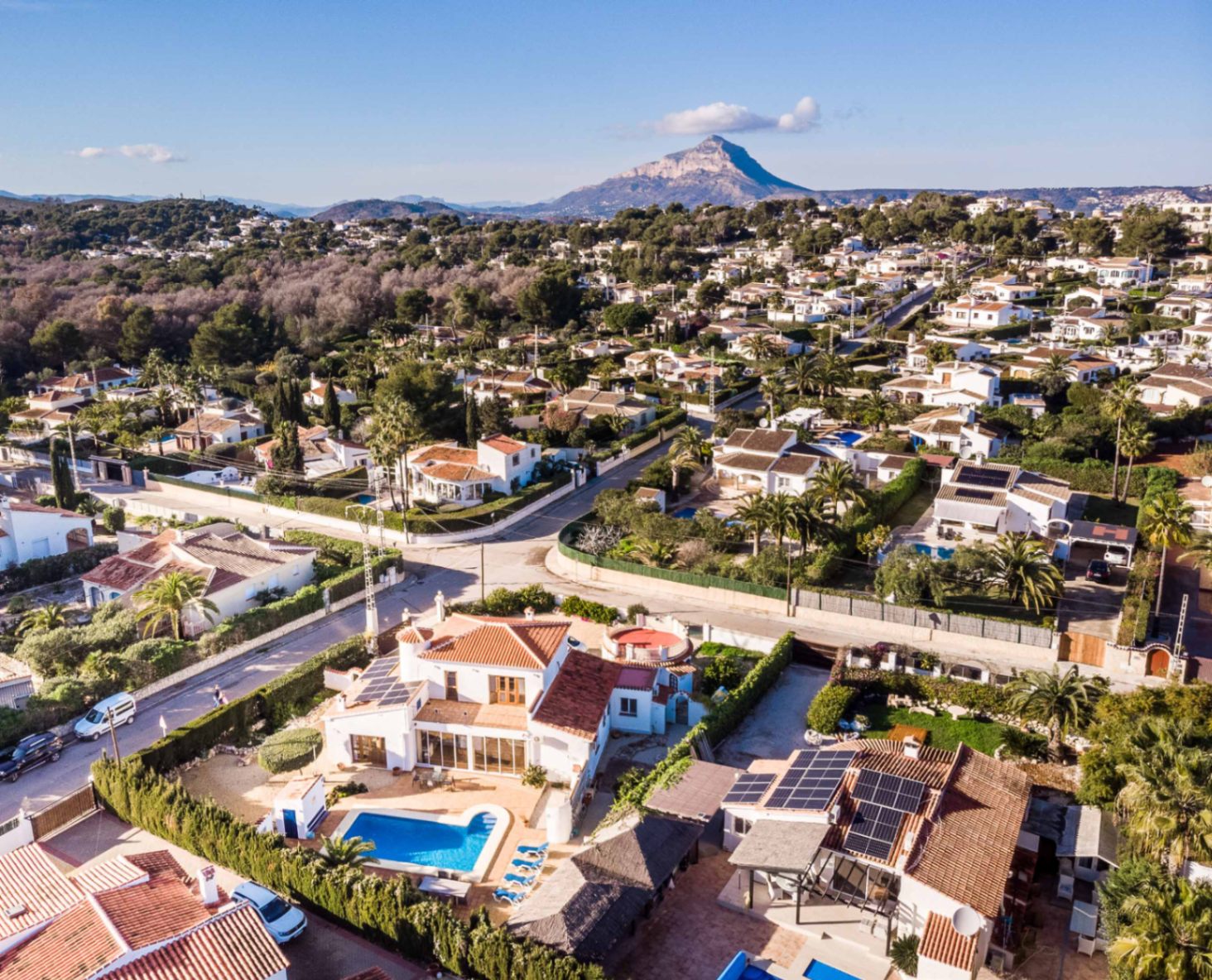 Aerial perspective of the villa in Costa Nova Pla, showcasing the private pool, rooftop solar panels, and the Montgó mountain backdrop.
