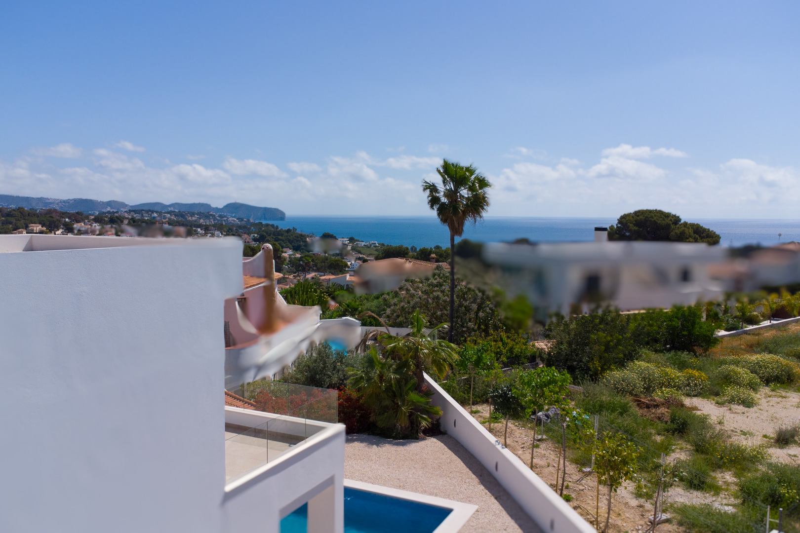 Panoramic Mediterranean Sea views from the upper level, overlooking the private pool, gravel terrace, and the expansive coastal landscape of Benissa.