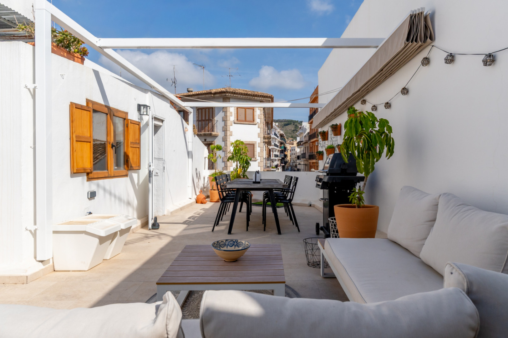 Terrace with dining area, barbecue, and views of Jávea's old town.