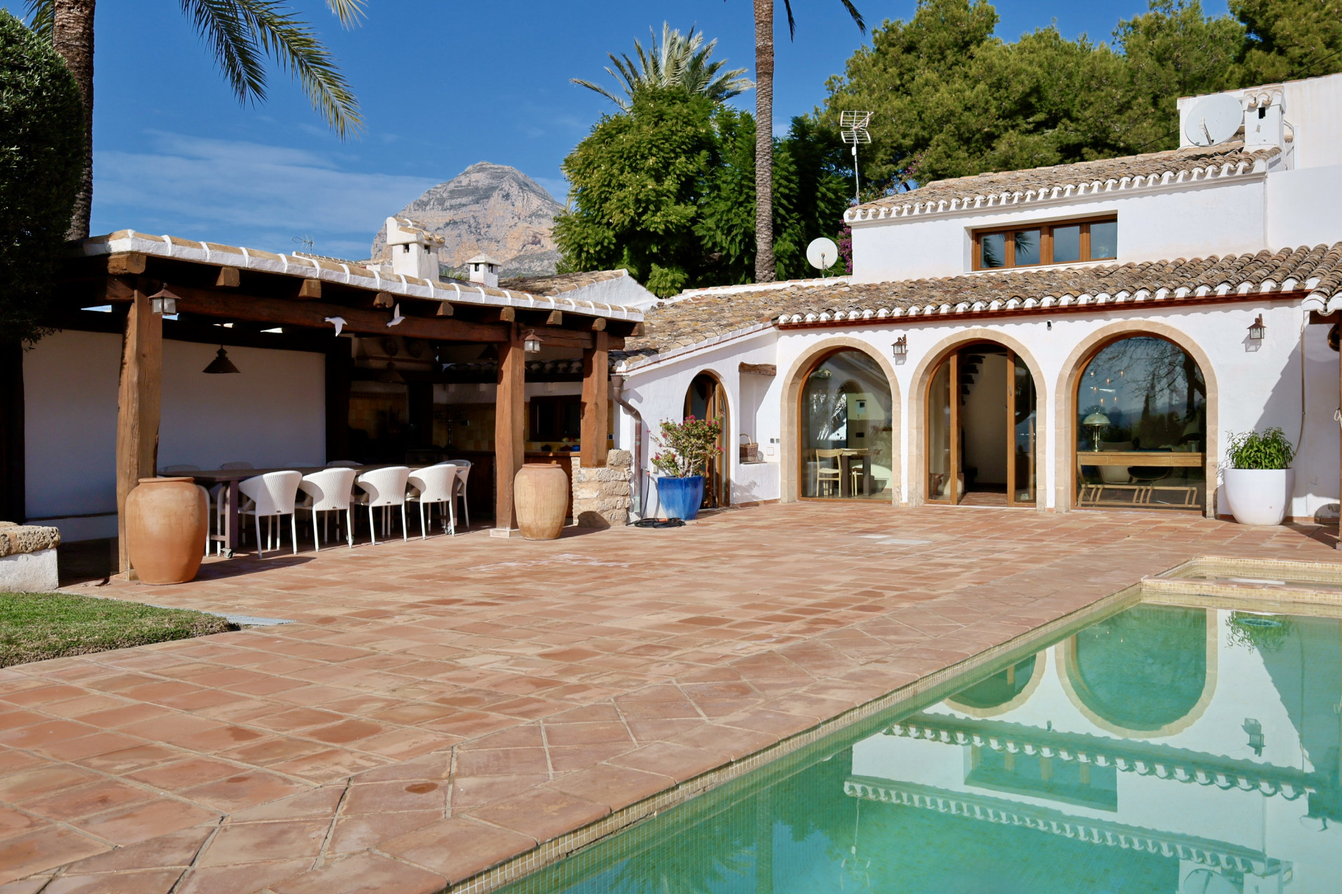 Terrace view with pool and covered outdoor dining area in Jávea.
