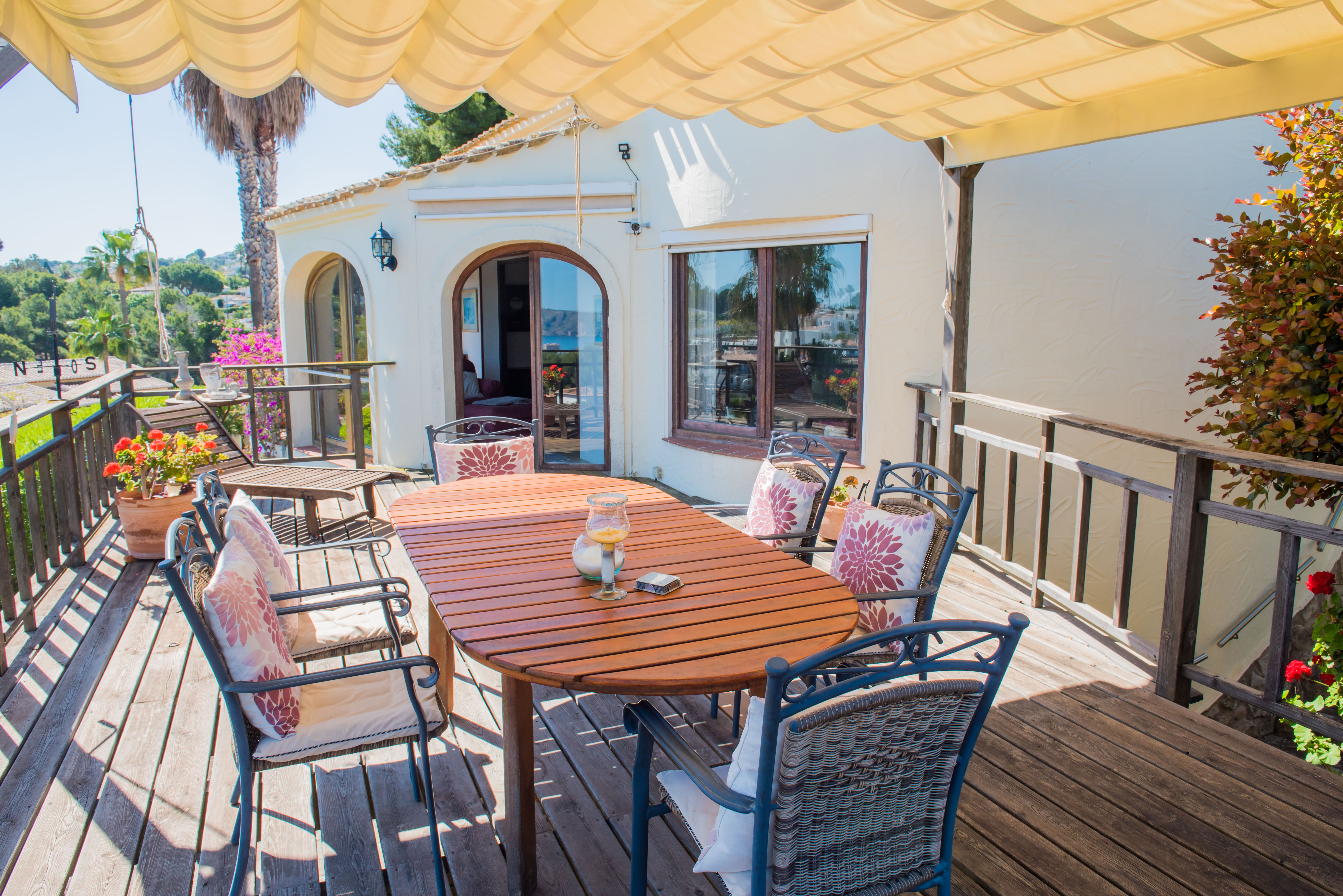 Covered terrace with wood table and upholstered chairs, perfect for enjoying panoramic views of the Mediterranean Sea. Covered terrace with wood table and upholstered chairs, perfect for enjoying panoramic views of the Mediterranean Sea.