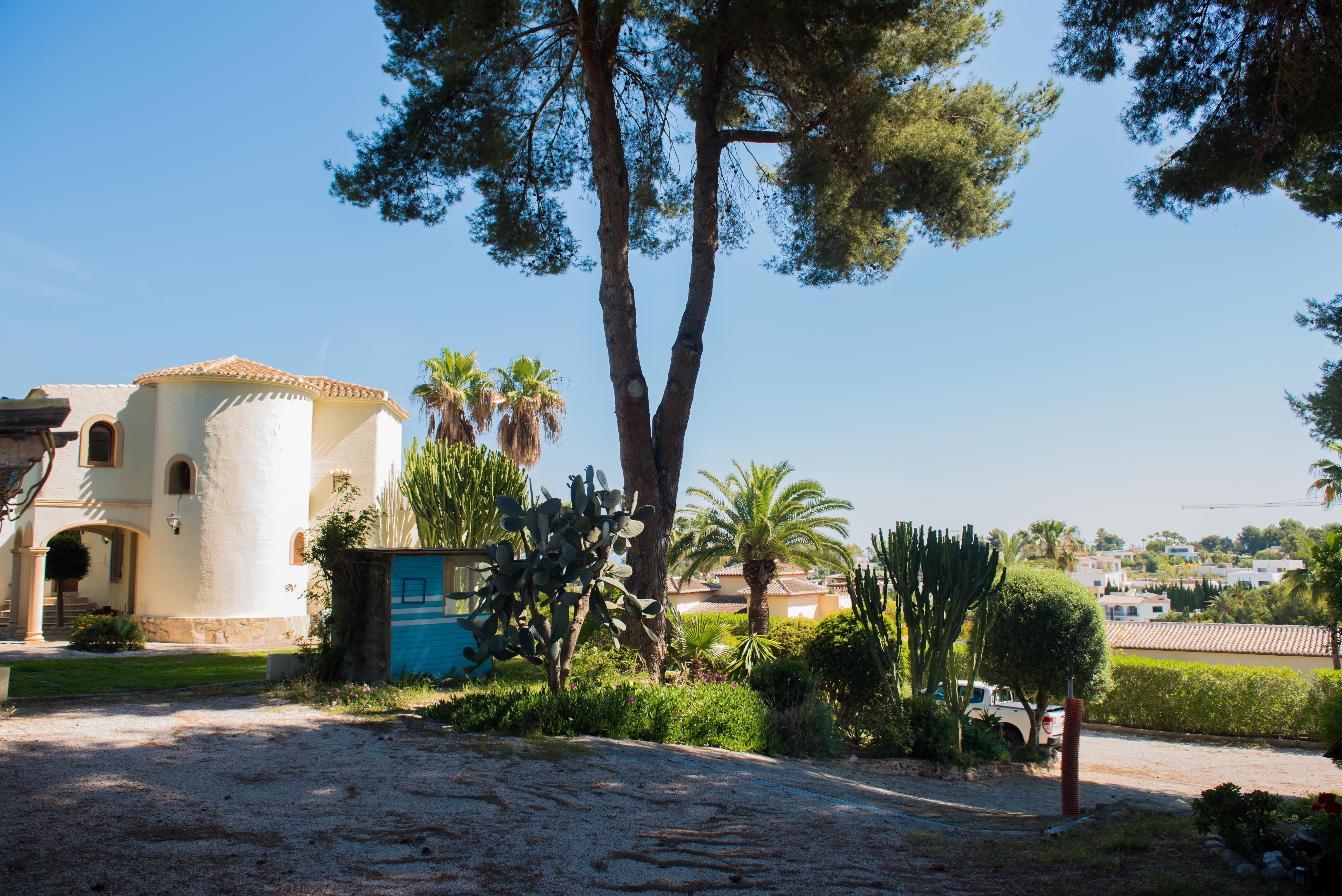 Exterior view of the Mediterranean villa, featuring unique architectural details and lush gardens. Exterior view of the Mediterranean villa, featuring unique architectural details and lush gardens.