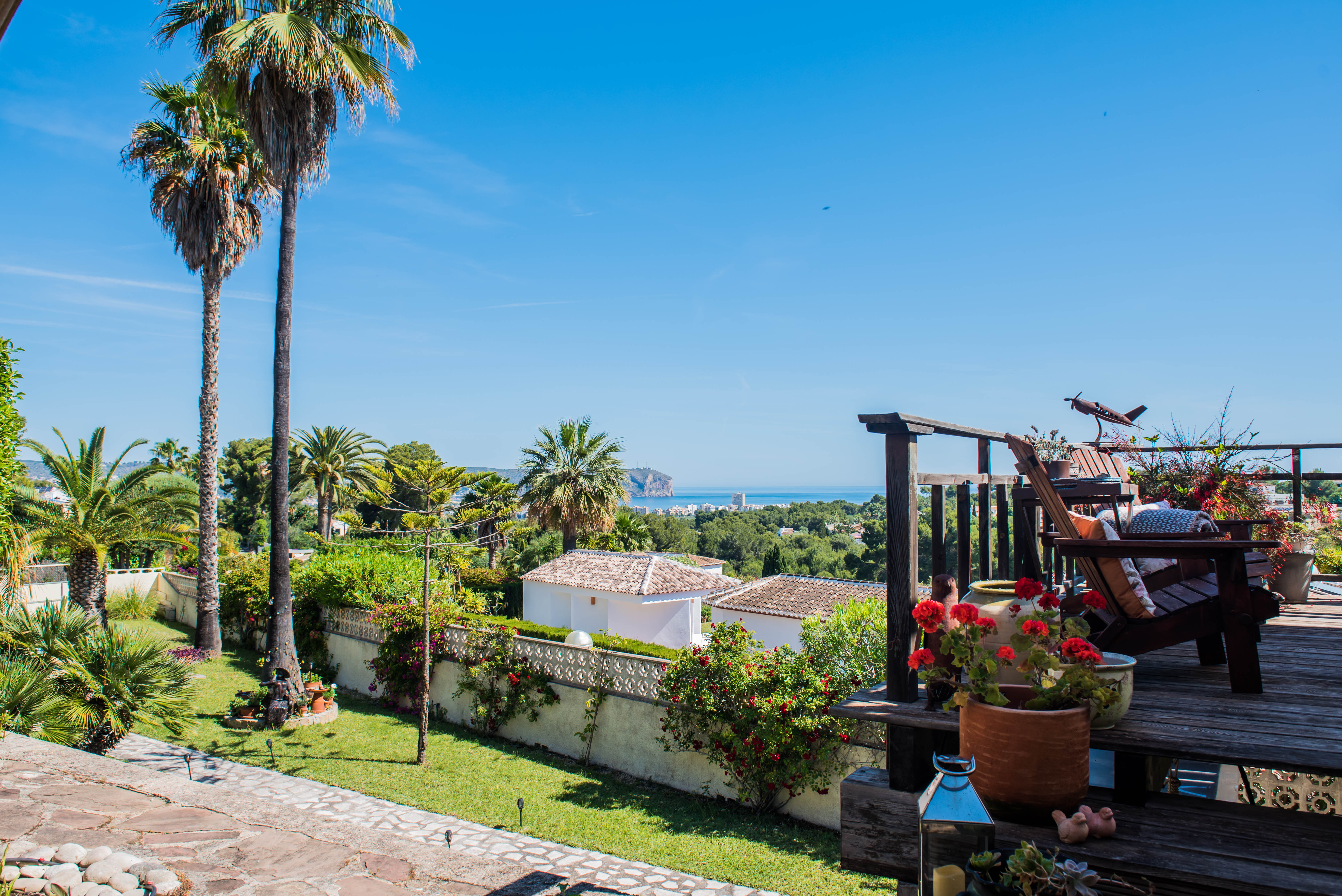 View from the wood terrace with bougainvillea and rustic armchairs overlooking the Mediterranean Sea. View from the wood terrace with bougainvillea and rustic armchairs overlooking the Mediterranean Sea.