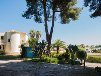 Exterior view of the Mediterranean villa, featuring unique architectural details and lush gardens.