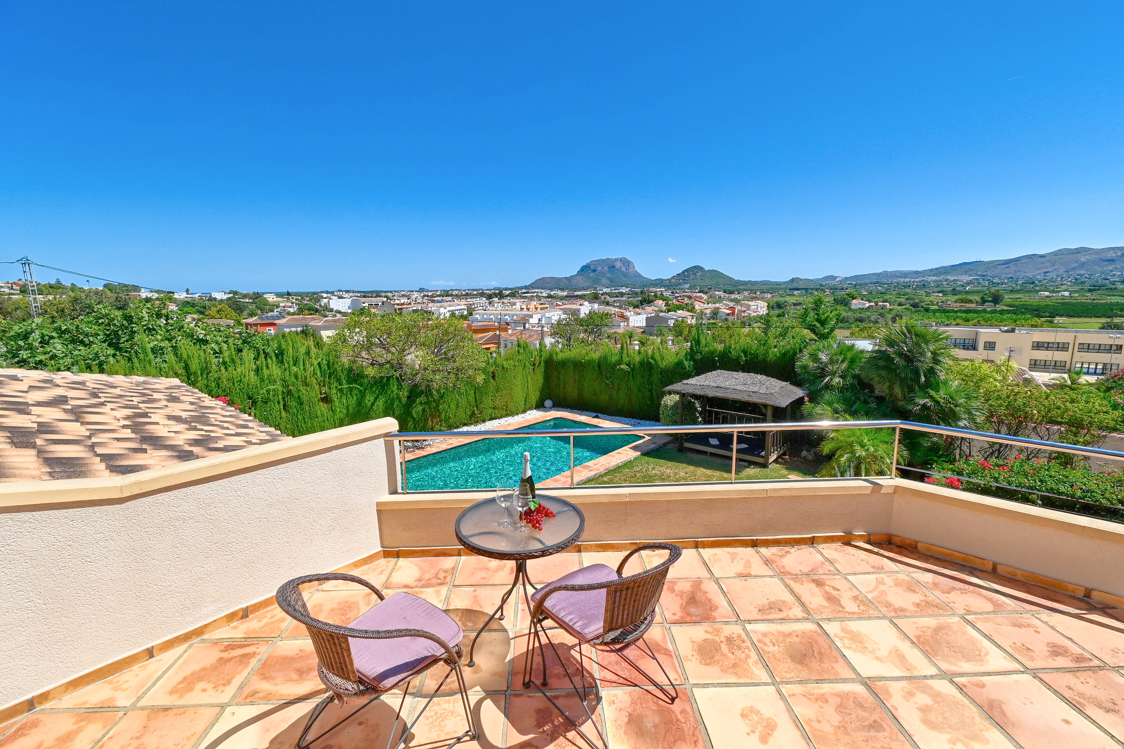 Terrace with bistro table, overlooking the pool and the mountainous landscape of Denia.