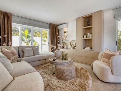 Bright living room featuring a modular sofa, round shag rug, and built-in storage unit.