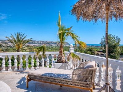 Sunny terrace featuring a rattan daybed and panoramic views of Jávea.