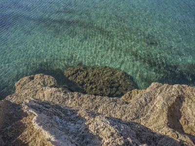 View of the rocky coastline with crystal-clear turquoise waters in Jávea, Costa Blanca.