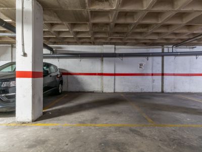 Underground parking space featuring a concrete floor and coffered ceiling.