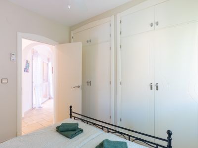 Bright bedroom featuring a designer built-in wardrobe and access to a terrace.