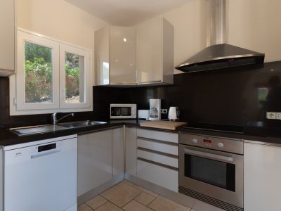 Modern kitchen featuring a black countertop and stainless steel appliances.
