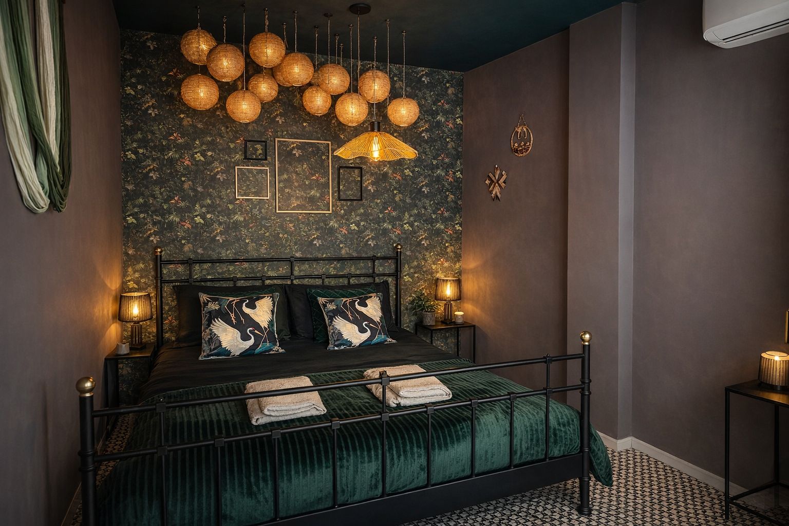 Bedroom featuring floral wallpaper, wrought iron bed, green velvet bedspread, and bedside lamps.