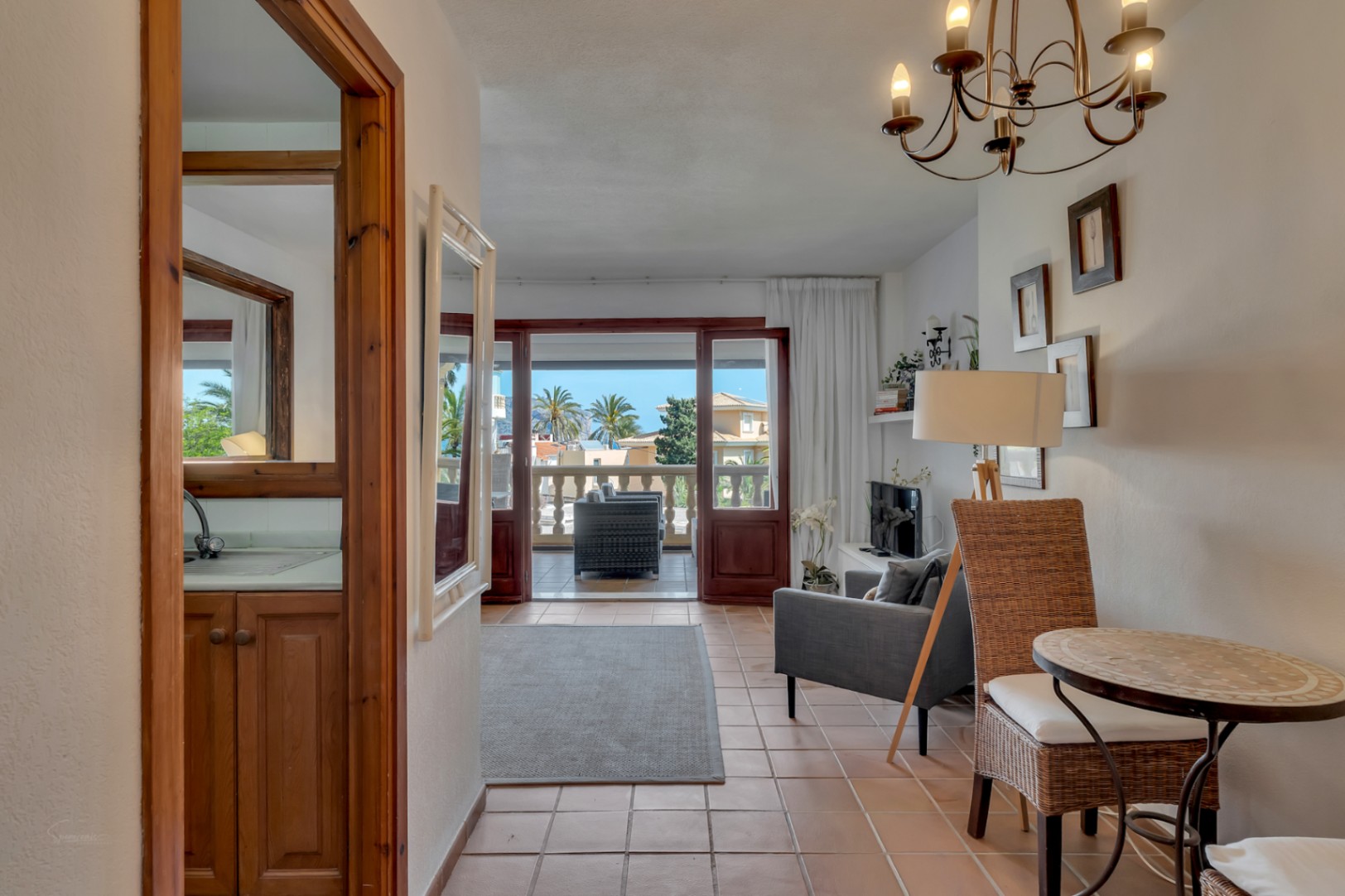 Bright interior featuring terrace access and sea views from the living room.