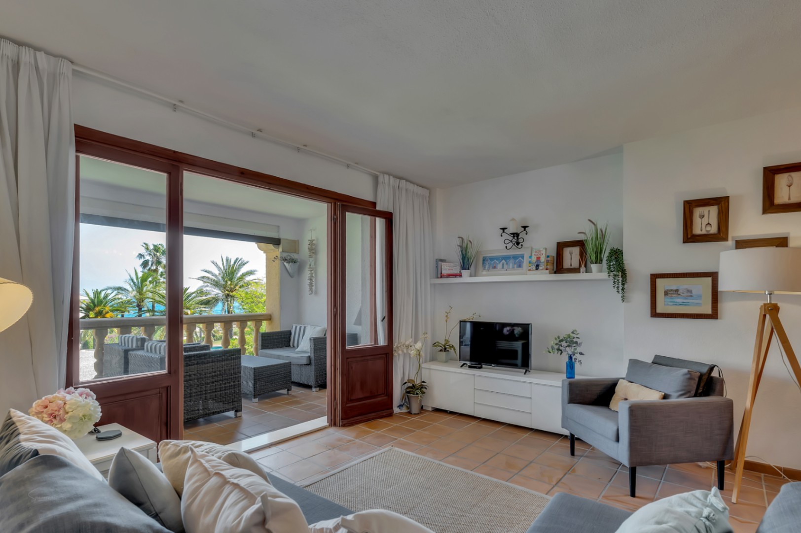 Bright living room with glazed terrace and Mediterranean sea views in Jávea.
