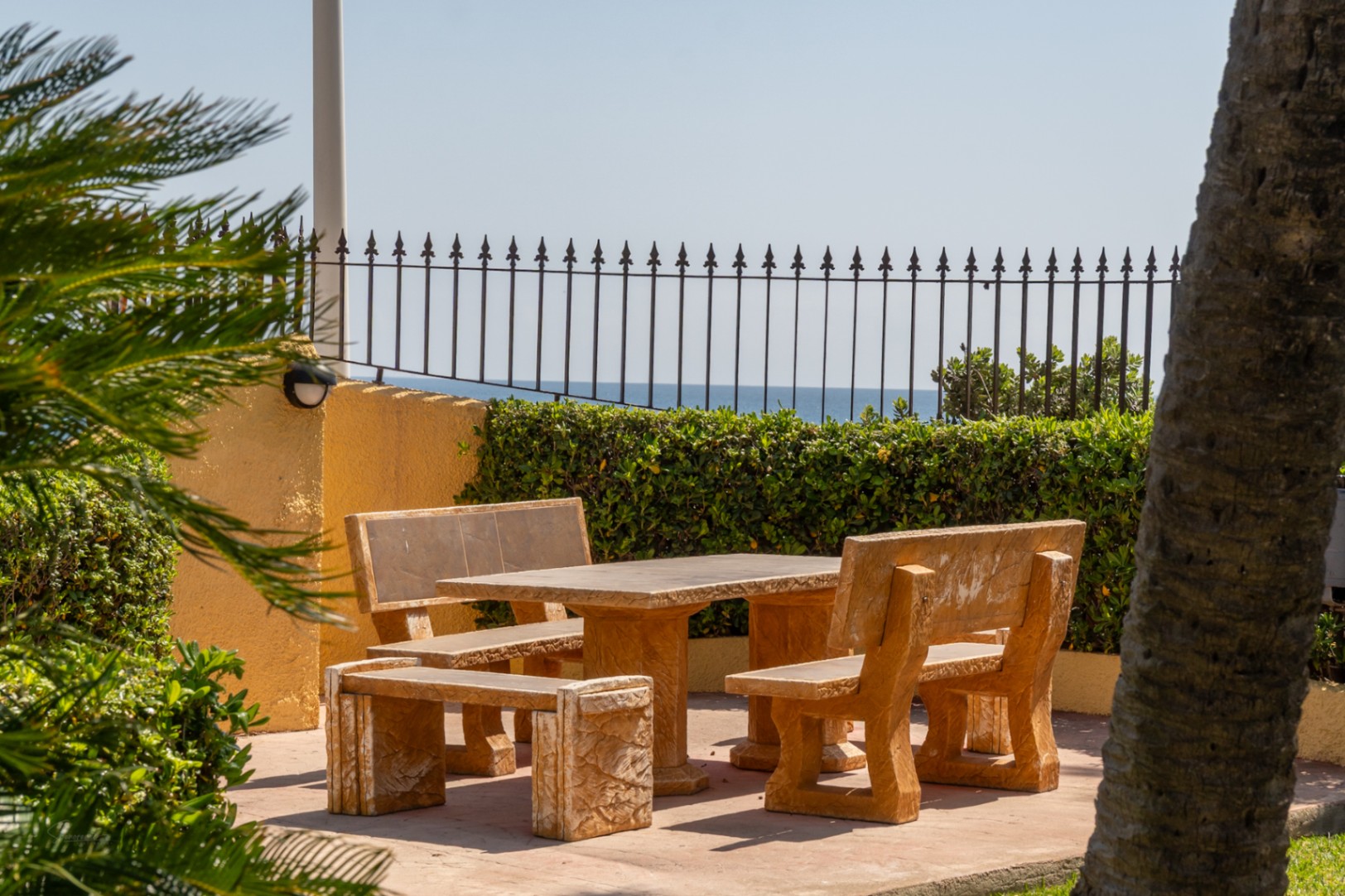 Patio with stone table and sea views in a landscaped urbanization in Jávea.
