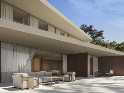 Modern villa exterior with expansive glass walls, dark wood paneling, and a light-tiled terrace featuring contemporary outdoor lounge and dining areas, surrounded by lush greenery.