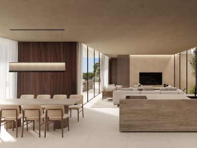 Spacious open-plan living area featuring a dining space with sea views, a stone kitchen island, and a lounge area with an internal garden view, all connected by large glass panels.